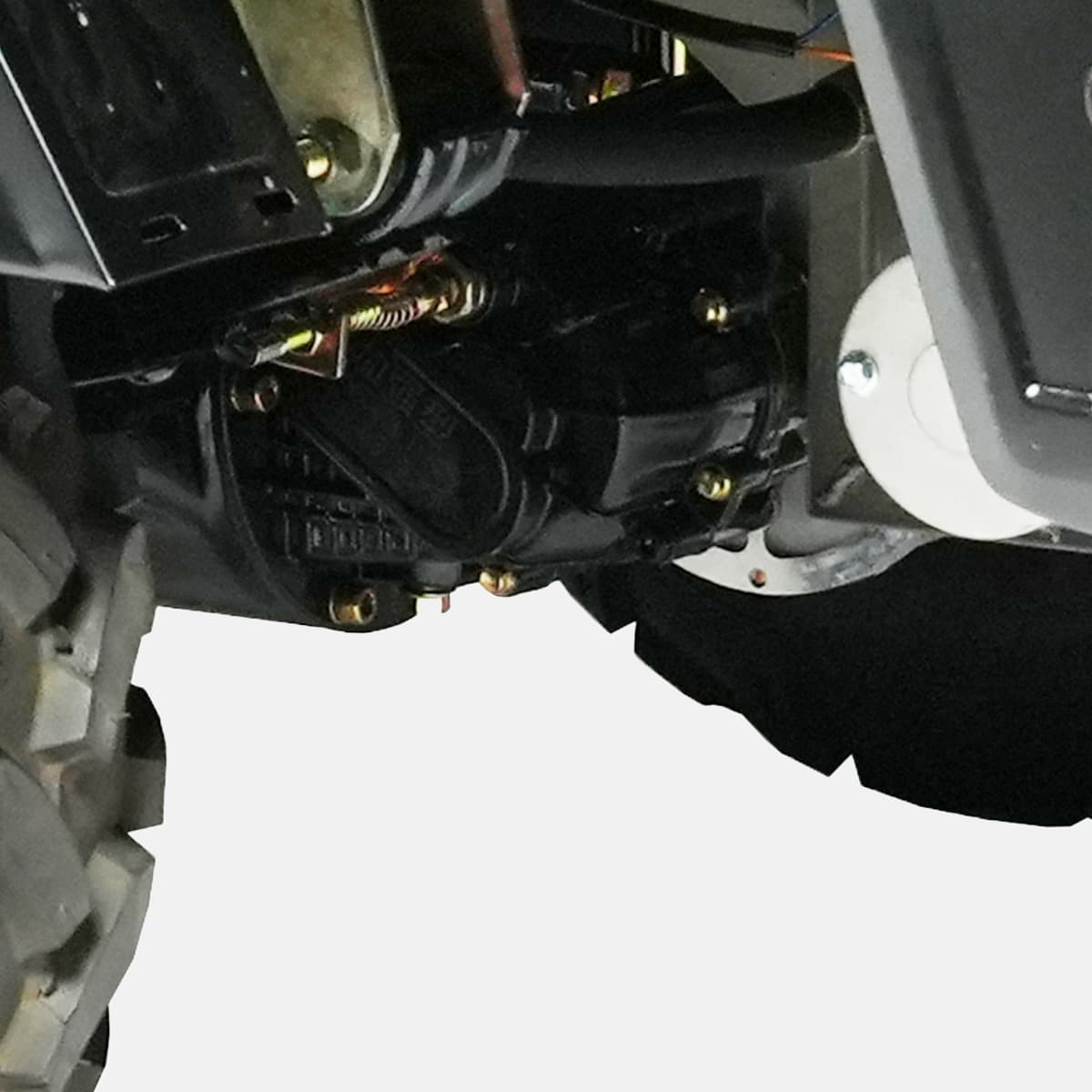 Close-up of a mechanical component on a vehicle with a gloved hand interacting with it.
