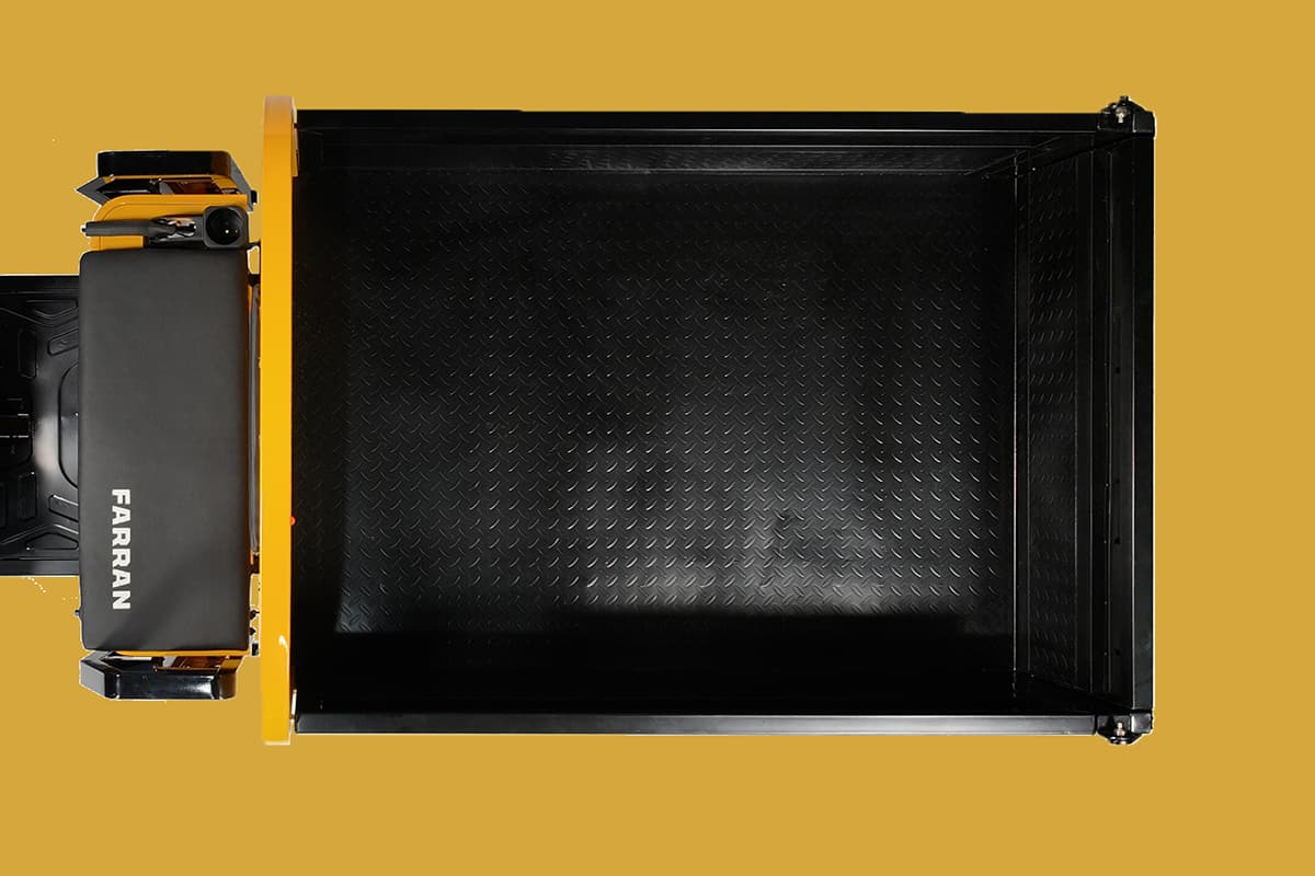 Black metal tray with yellow sides on a yellow background