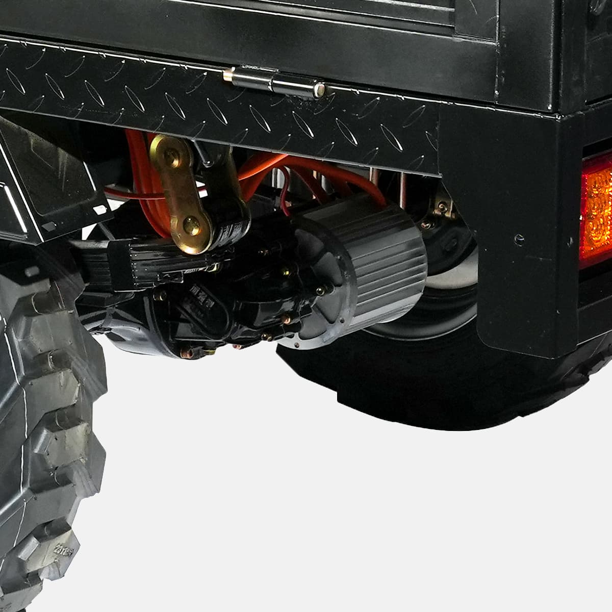 Close-up of a vehicle's undercarriage with visible wiring and components on a white background