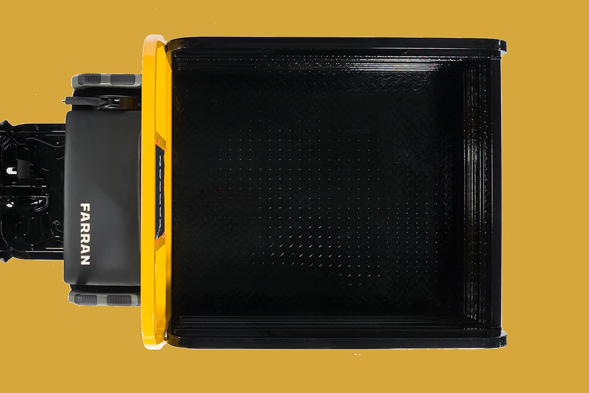 Black toolbox with yellow handle on a mustard yellow background